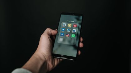 photo of hand holding a black smartphone